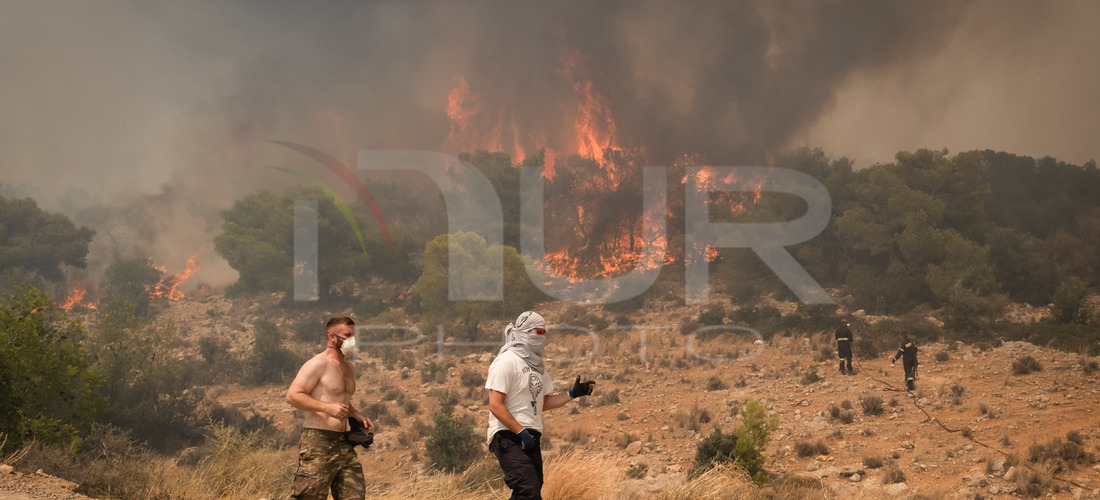 

Firefighters are trying to extinguish a wildfire in Nea Zoi, Nea Peramos, near Megara, Greece on July 19, 2023. After three days, firefigh...