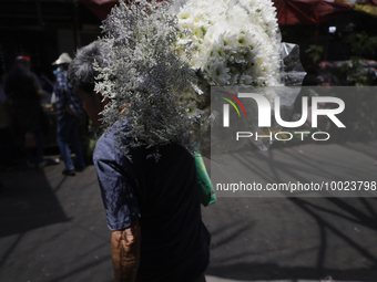 A person holds a bouquet of flowers inside the Jamaica Market in Mexico City where dozens of people came to buy flowers and gifts for Mother...
