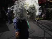 A person holds a bouquet of flowers inside the Jamaica Market in Mexico City where dozens of people came to buy flowers and gifts for Mother...