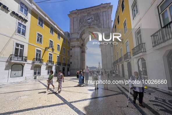 People are seen walking near the Augusta arch in Praca de Comercio, in the Baixa neighborhood, Lisbon. 02 May 2023. 