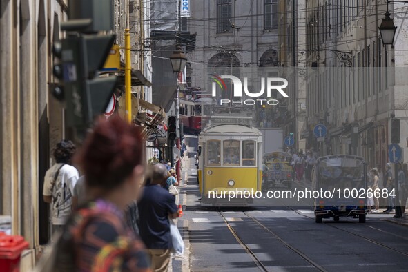 Trams are seen passing through one of the streets in the neighborhood of Baixa, Lisbon. 02 May 2023. 
