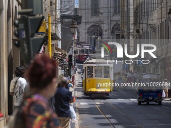 Trams are seen passing through one of the streets in the neighborhood of Baixa, Lisbon. 02 May 2023. (