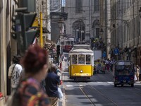 Trams are seen passing through one of the streets in the neighborhood of Baixa, Lisbon. 02 May 2023. (