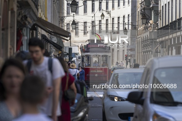 Trams are seen passing through one of the streets in the neighborhood of Baixa, Lisbon. 02 May 2023. 