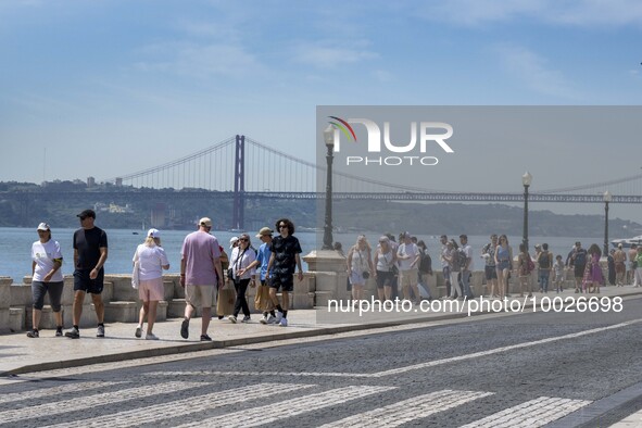 Several people are seen walking near the Tejo river bank, in the Baixa neighborhood, Lisbon. 02 May 2023. 
