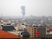 Smoke rises above buildings in Gaza city following an Israeli air strike on May 12, 2023. Israel and Gaza militants traded heavy fire on May...