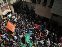 Mourners carry the flag-draped body of Islamic Jihad official Iyad al-Hassani, killed in an Israeli air strike, during his funeral processio...