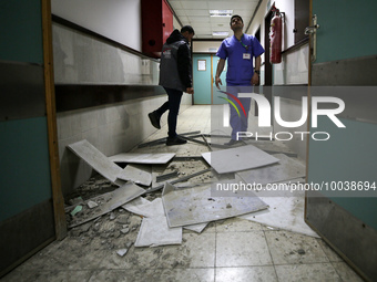 A doctor inspect a hospital damaged in a nearby Israeli strike, in the central Gaza Strip May 13, 2023. (