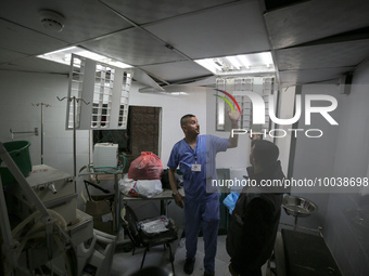 A doctor inspect a hospital damaged in a nearby Israeli strike, in the central Gaza Strip May 13, 2023. (