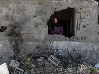 A Palestinian woman looks amidst the rubble of her house in Gaza City, on May 14, 2023, following a ceasefire ending five days of deadly fi...