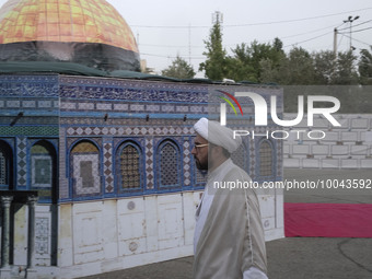 An Iranian cleric walks past a scale model of Al-Aqsa mosque during an anti-Israel ceremony at the Imam Khomeini grand mosque in downtown Te...