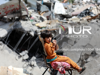 A Palestinian boy sits amidst the rubble of his house in Gaza City, on May 15, 2023, following a ceasefire ending five days of deadly fighti...