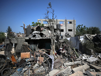 A Palestinian man walks amidst the rubble of his house in Gaza City, on May 15, 2023, following a ceasefire ending five days of deadly fight...