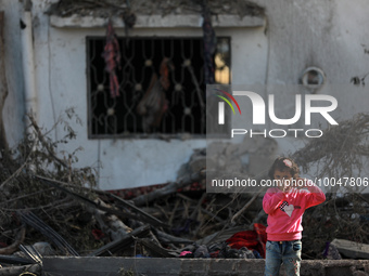 A Palestinian girl stands past a house destroyed in an Israeli strike in the recent Gaza-Israel fighting, following a ceasefire agreed betwe...