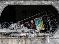 A Palestinian girl looks at the rubble of a building, following an Israeli air strike, following a ceasefire ending five days of deadly figh...