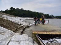 Repair work underway after heavy soil erosion by river Brahmaputra at Mayong village in Morigaon District of Assam , India  on May 21 ,2023...