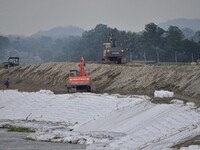 Repair work underway after heavy soil erosion by river Brahmaputra at Mayong village in Morigaon District of Assam , India  on May 21 ,2023...