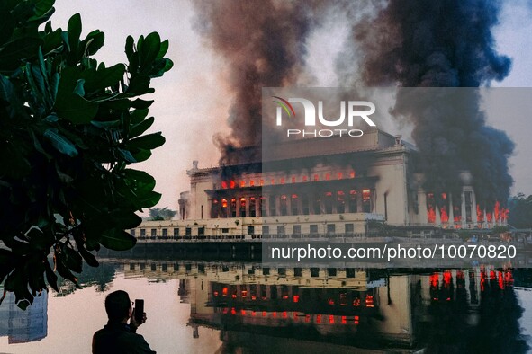 A bystander captures footage of the huge fire engulfing Manila's Central Post Office in the Philippines on May 22, 2023. The historic buildi...