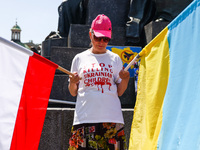 A protester holds Polish and Ukrainian flags during a daily demonstration of solidarity with Ukraine at the Main Square in Krakow, Poland on...