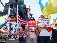 Protesters hold banners and flags during a daily demonstration of solidarity with Ukraine at the Main Square in Krakow, Poland on May 21, 20...