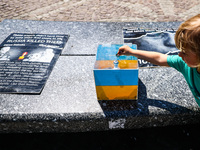 A money box for support of Ukraine is seen during a daily demonstration of solidarity with Ukraine at the Main Square in Krakow, Poland on M...