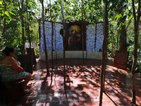 Faithful place the ribbons with thanks for Mary Undoer of Knots in the sanctuary located in the jungle of Cancun, the only church of its kin...
