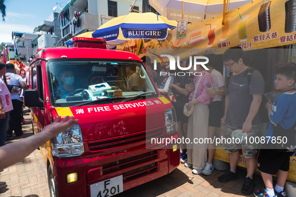 

A fire services vehicle is passing through the tight streets of Cheung Chau in Hong Kong, China, on May 26, 2023, as the Bun Festival take...