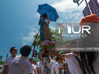 

A child in traditional dress is being hoisted and carried around under the scorching sun during a traditional procession in Cheung Chau, H...