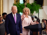 Head Coach of the Louisiana State University Women’s basketball team shares a laugh with President Joe Biden as she begins her remarks.  Pre...