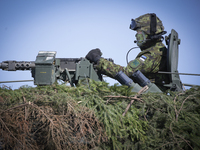 An Estonian soldier is seen in a camouflaged armoured personnel carrier in Tapa, Estonia on 20 May, 2023. Estonia is hosting the Spring Stor...