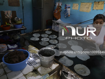 A woman makes blue corn tortillas by hand inside a market in the town of Amecameca, State of Mexico.

Recently, the Government of the Stat...