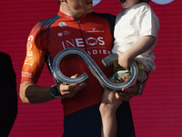 On second place Geraint Thomas of The United Kingdom and Team INEOS Grenadiers and his son pose on the podium ceremony after the 106th Giro...