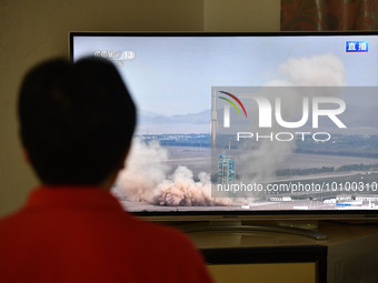 FUYANG, CHINA - MAY 30, 2023 - A citizen watches a live broadcast of the launch of the Shenzhou 16 manned spacecraft in Fuyang city, Anhui p...