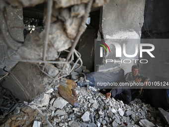 

A Palestinian man is sitting in his house, which was destroyed by Israeli air strikes during recent Israel-Gaza fighting, in Beit Lahiya,...