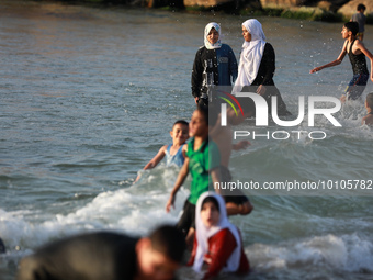 Palestinians enjoy swimming in the Mediterranean sea on the coast of Gaza City, on May 31, 2023.  (