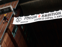 Two climbers from XR Toulouse (Extinction Rebellion) climbed on the facade of the Mediatheque of Toulouse to put a banner reading ' 0 ambiti...