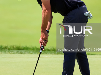 Mark Hubbard of Denver, Colorado taps in his ball on the 18th green during the first round of the The Memorial Tournament presented by Workd...