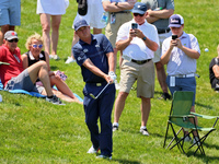Jason Dufner of Auburn, Alabama chips from the rough in the seating area onto  the 18th green during the first round of the The Memorial Tou...
