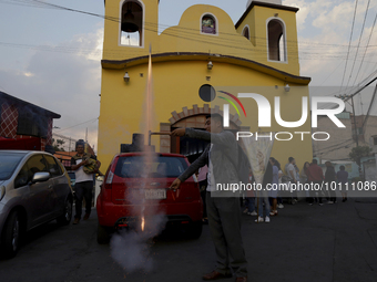 A group of people during a procession outside a parish church in the town of San Francisco Culhuacan in Mexico City, where they went to the...