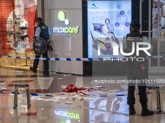 Police officers standing guard at the crime scene on June 2, 2023 in Hong Kong, China. Two women were stabbed to death by a man inside a sho...