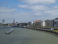 General view during a sunny day of the waterfront of the city of Düsseldorf with the parks and buildings alongside and Rhine river bank from...