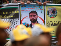 Palestinians take part in a protest in front of the Red Cross office, on May 5, 2014 demanding the release of their relatives held prisoner...