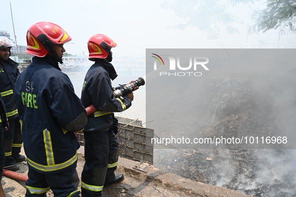 Firefighters trying to extinguish a fire that broke out at Shadarghut wholesale fruit Market in Dhaka, Bangladesh, on June 3, 2023  