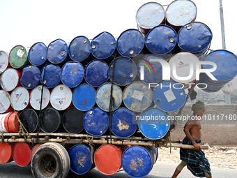 Worker carries empty drum by the wheelbarrow during high temperature weather day in Dhaka, Bangladesh, June 3, 2023 (