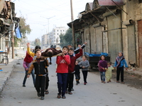 Children playing game martyr in Aleppo January 21, 1, 2016. Live their day to the sound of bullets, playing but they do not go to school bec...