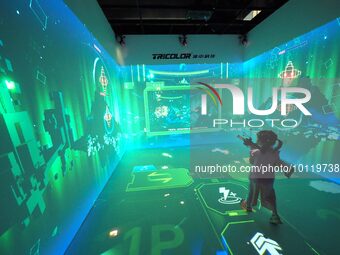 BEIJING, CHINA - JUNE 4, 2023 - Children have an immersive shooting experience at the 2023 Science Fiction Industry New Technology and New P...
