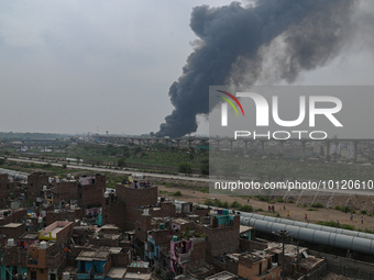 Smoke clouds can be seen in the air after a fire was broke out in the slum cluster of Jahangirpuri area in New Delhi, India on June 4, 2023....