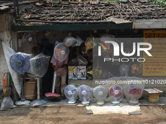 A person is displaying fans outside a shop during a Heatwave on the outskirts of Kolkata, India on 04 June 2023. This is the third heat wave...
