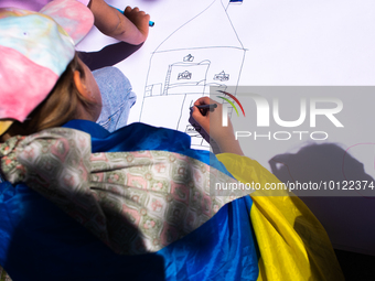 

A Ukrainian child is drawing a house during a demonstration and calling for the EU to save Ukrainian children in Dusseldorf, Germany, on J...