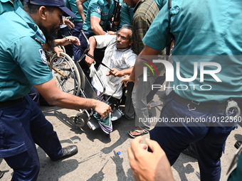 Police scuffle with disabled people as they protest demanding to raise their government allowance, in Dhaka, Bangladesh, on June 4, 2023 (